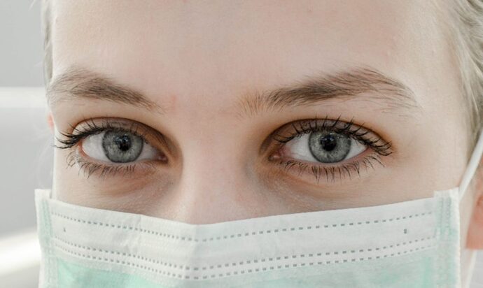 Wearing a mask can harm your health. woman wearing a mask courtesy of Ani Kolleshi via Unsplash. | Jennifer Margulis, Ph.D.