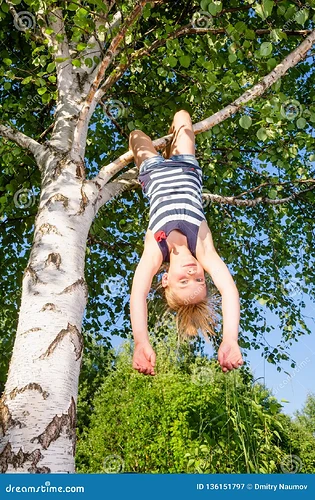 girl hanging from tree