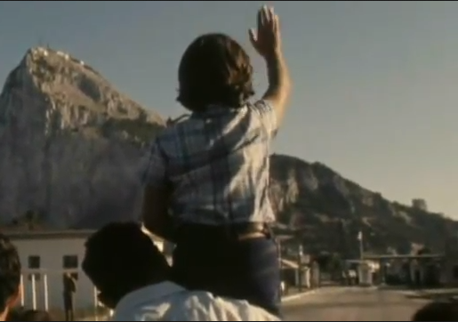 Boy waves to family